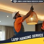 HMSD Handyman Services Dubai electrician hanging a lamp for professional lighting installation