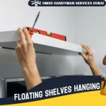 Expert handyman in Dubai installing shelves securely on a wall